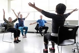 Parkinson's disease patients take part in a special yoga class.