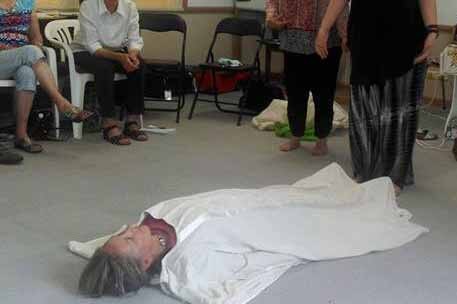 Woman is wrapped up during natural burial workshop