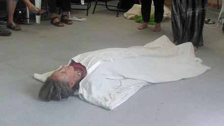 Woman is wrapped up during natural burial workshop