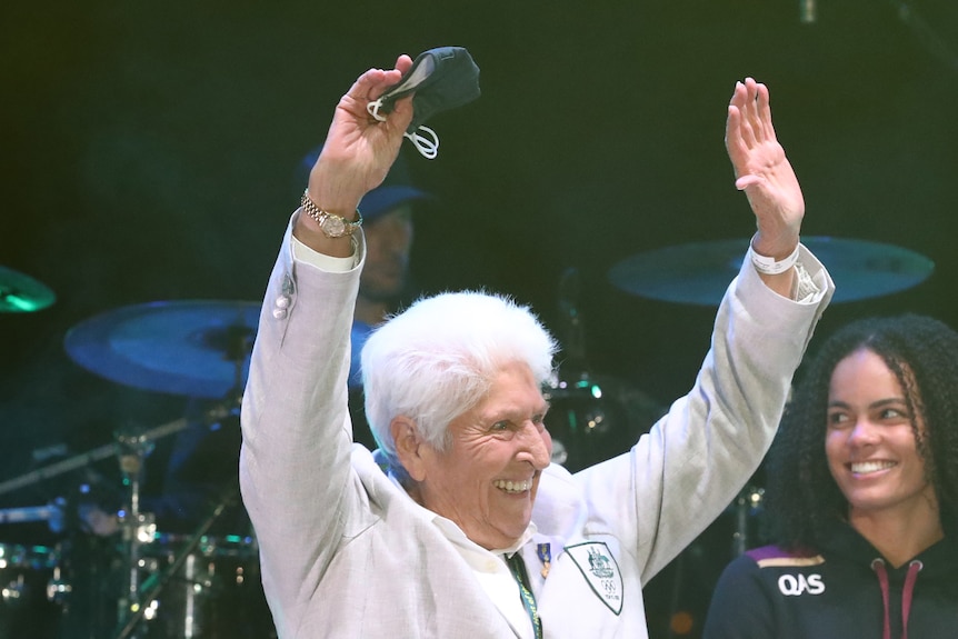 Dawn Fraser smiling with hands up in the air.