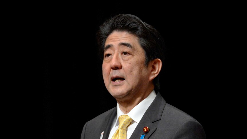 Japanese Prime Minister Shinzo Abe delivers a speech during a national meeting to demand the return of what Japan calls the Northern Territories, seized by Russia in the closing days of WWII and called the Kurils in Tokyo on February 7, 2013. Some 2,000 people inclucing former residents of the Northern Territories attended the meeting. AFP PHOTO