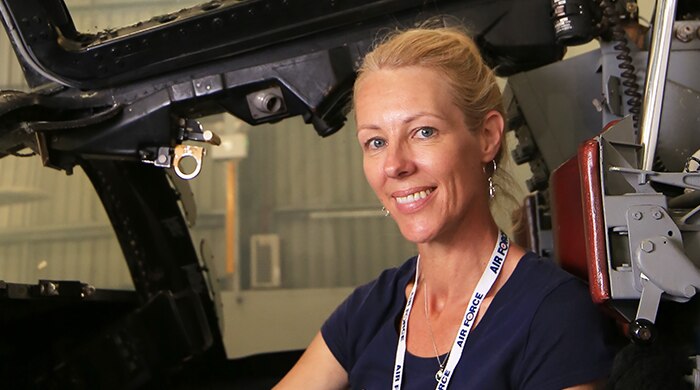 Melinda Andersson sits inside the F1-11 cockpit with the door up.