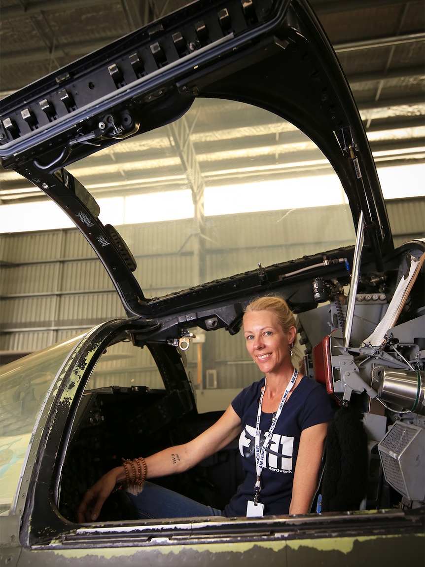 Melinda Andersson sits inside the F1-11 cockpit with the door up.