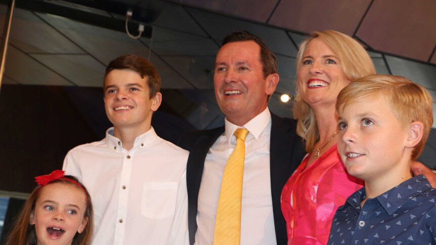 Mark McGowan with his arm around his wife Sarah and three children.