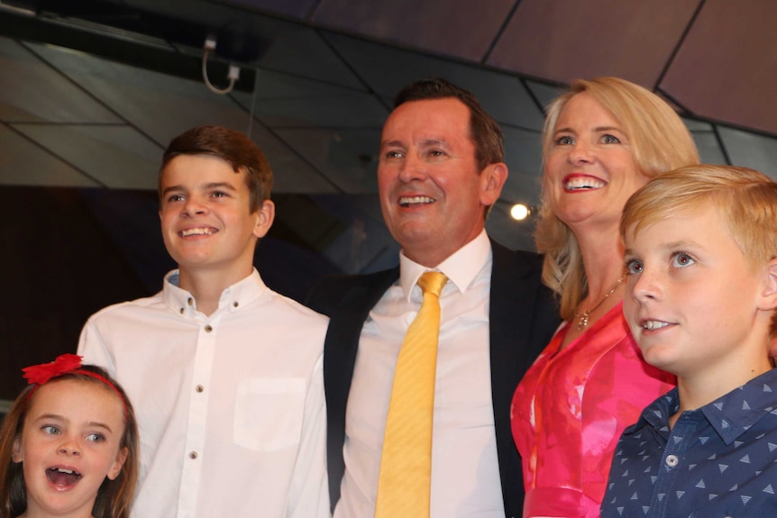 Mark McGowan with his arm around his wife Sarah and three children.