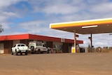 Shell service station forecourt with a police car parked out the front.