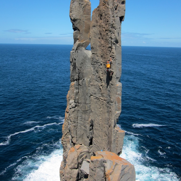 A climber on Pole Dancer at Cape Raoul
