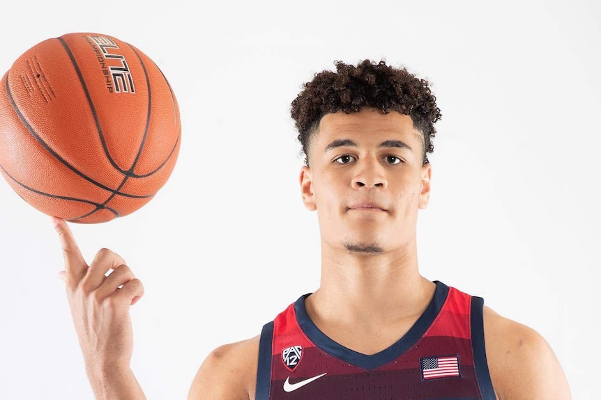 Josh green spins a basketball on his finger while wearing an Arizona jersey.