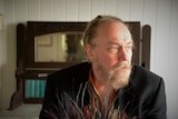 Ed Kuepper, a man with a light brown beard, stares into the distance