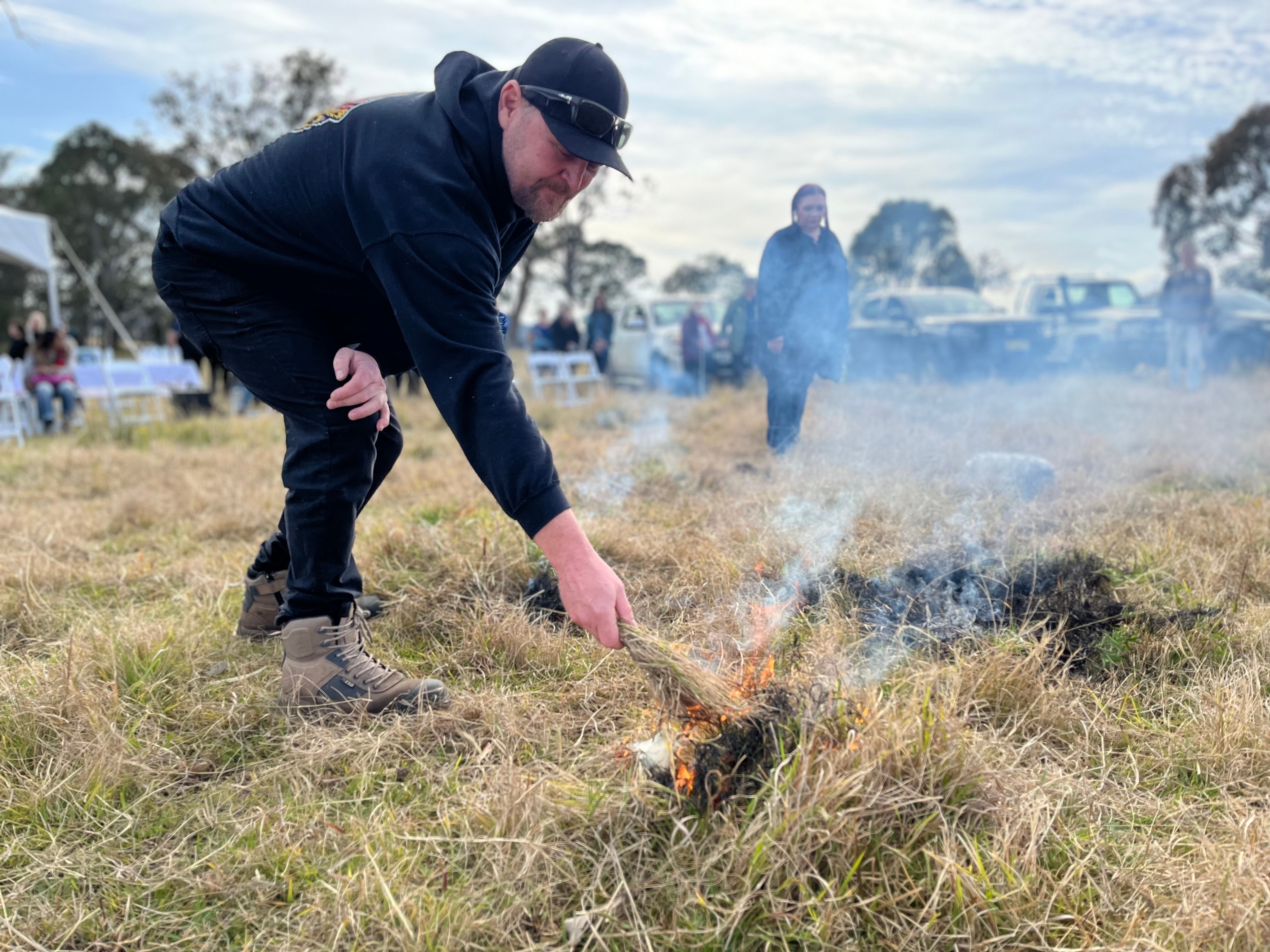 A man conducting cultural burning in grassland
