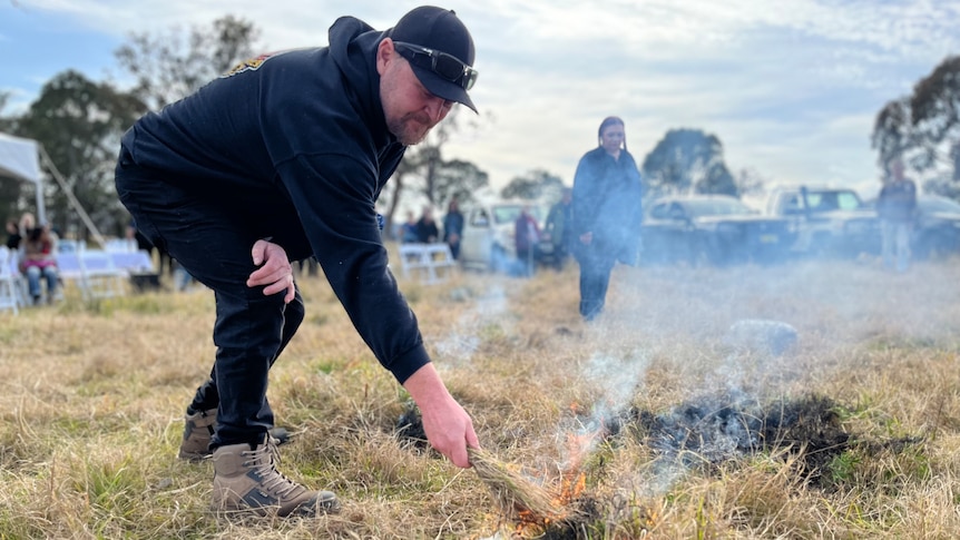 A man conducting cultural burning in grassland