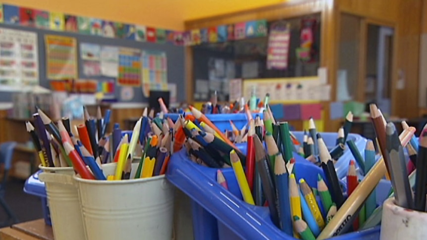 Classroom with pencils in foreground.