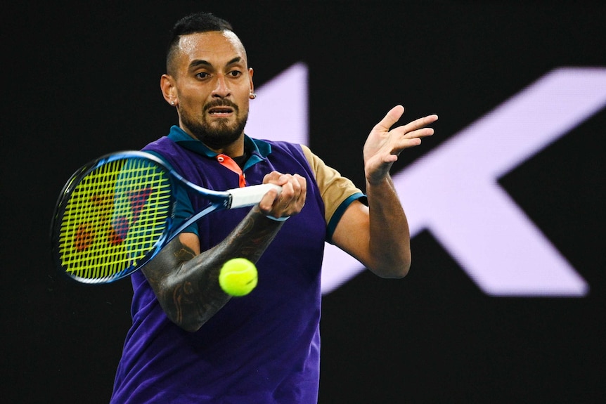 Nick Kyrgios grimaces as he makes contact with a forehand