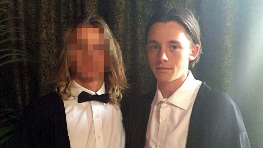 Jamie Murphy and his friend (face blurred) wearing tuxedos.