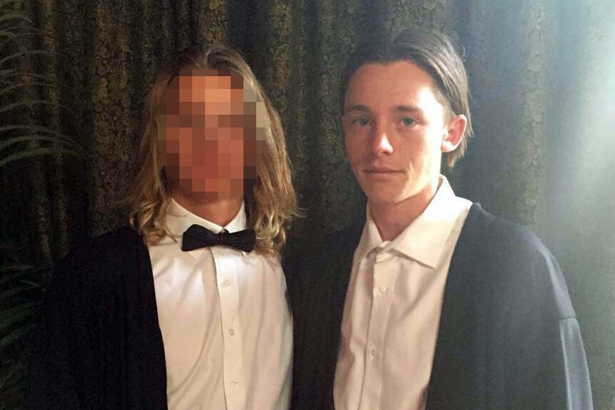 Jamie Murphy and his friend (face blurred) wearing tuxedos.