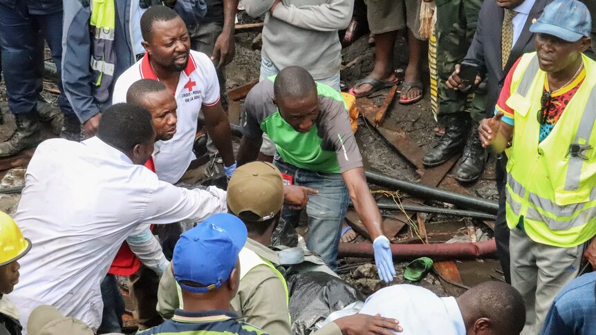 people search through dirt and debris for bodies from the small plane crash in Congo