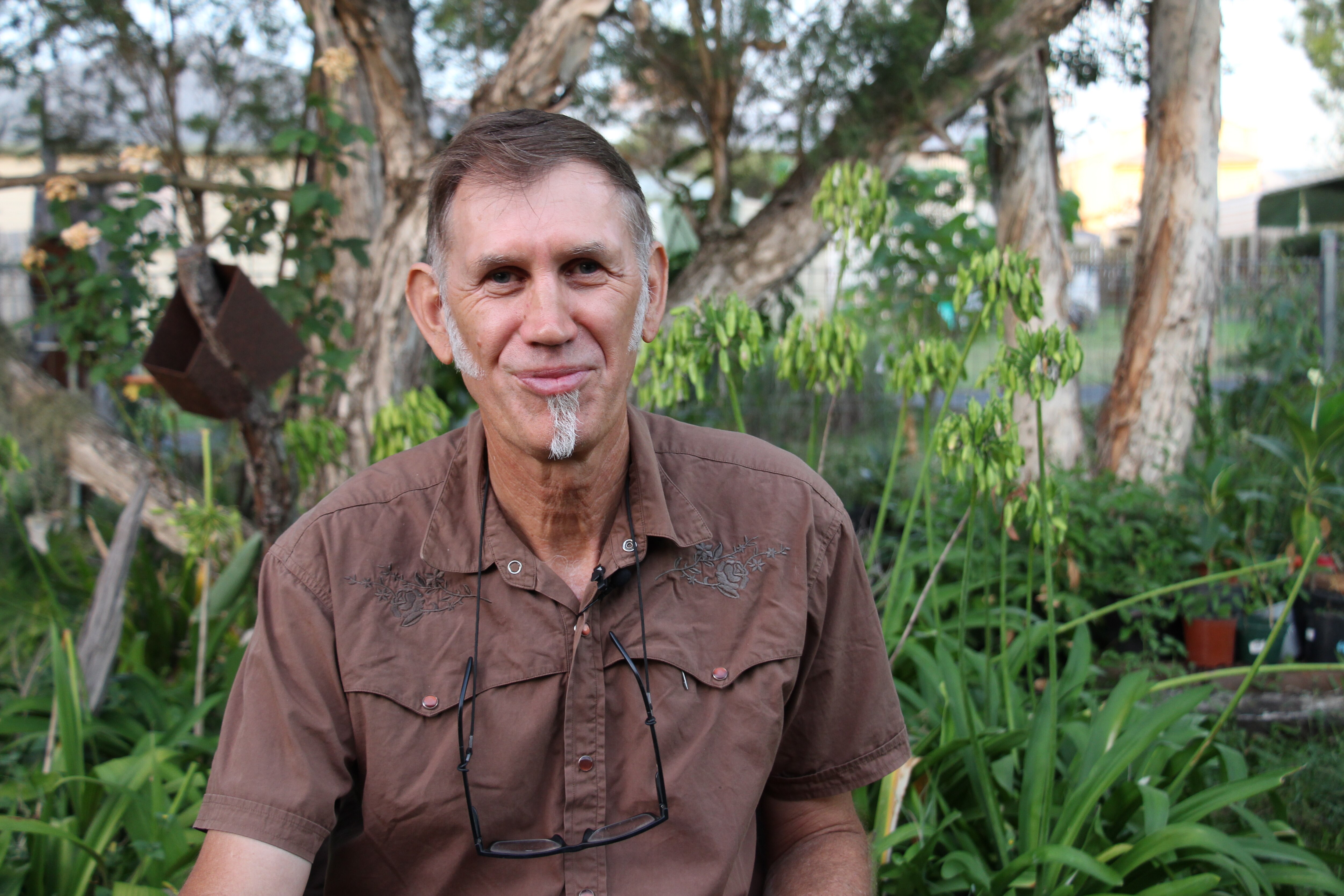 A man sitting in his garden
