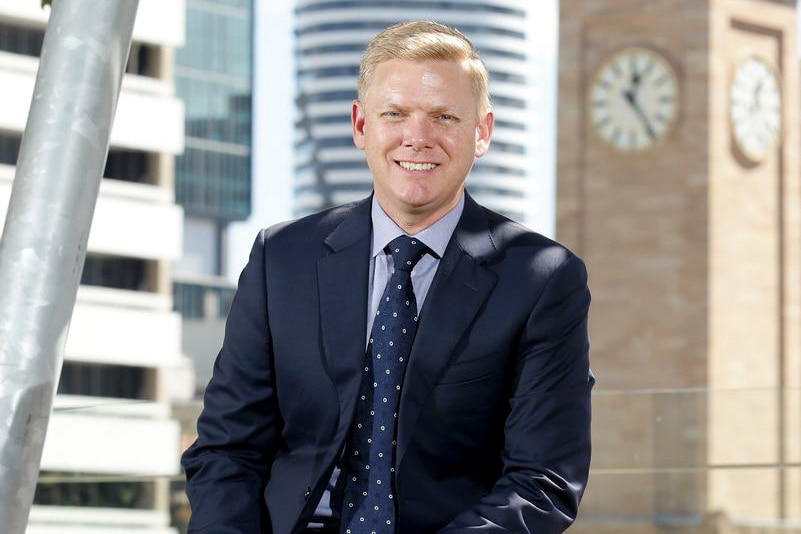 Brett Fraser sits in front of the Brisbane clock tower