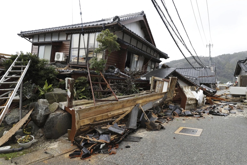 A damaged house on the road after an earthquake