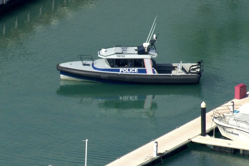 A police boat turns in a boat pen