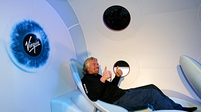 Sir Richard Branson gives a thumbs up to the SpaceShip2