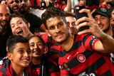 Man of the moment ... Dario Vidosic poses with Wanderers fans after securing victory in extra time