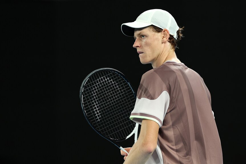 Jannik Sinner clutches his racquet during the Australian Open final.
