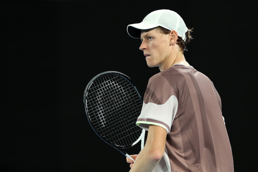Jannik Sinner clutches his racquet during the Australian Open final.