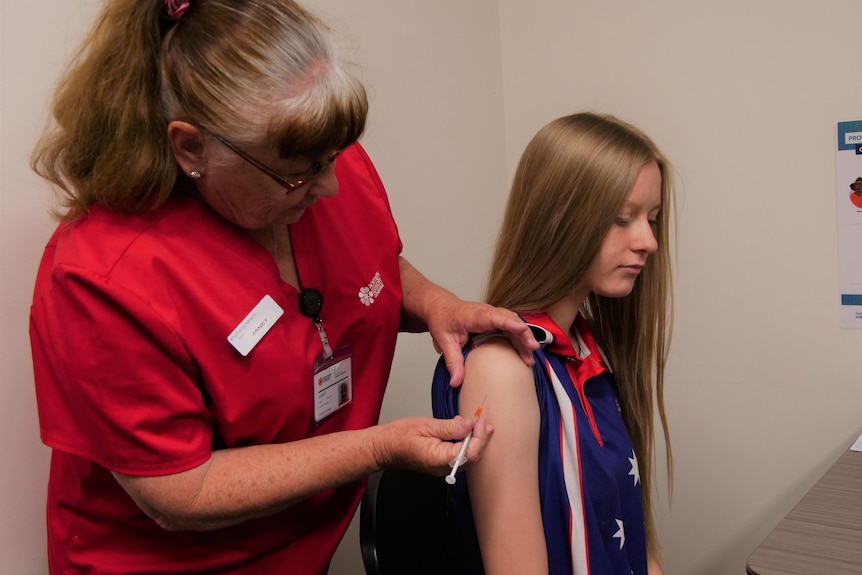 A young girl receives a COVID-19 vaccination in Katherine.