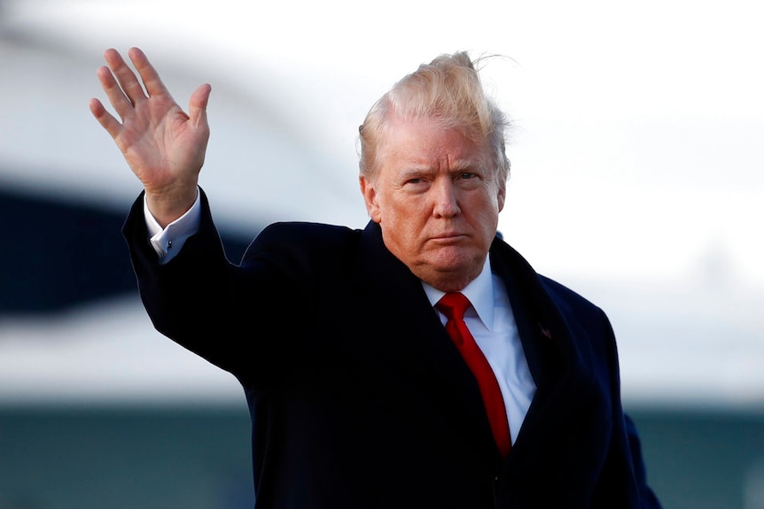 President Donald Trump waves as he walks from Air Force One.