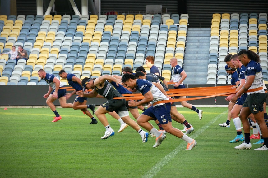 Cowboys players training on-field at the Townsville stadium 