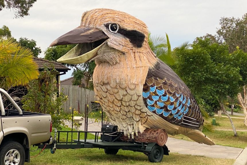 A giant statue of a kookaburra built on the back of a mobile trailer