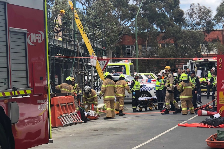 Emergency workers at the scene of a crane accident.