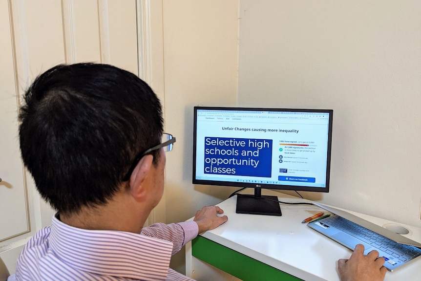 A man sits next to the computer