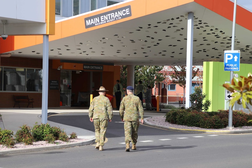 Two army personnel walking outside the North West Regional Hospital in Burnie