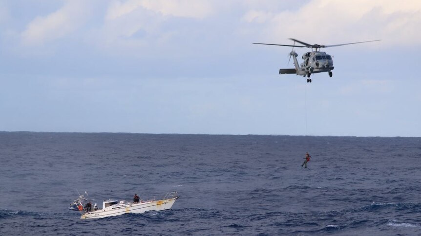The Royal Australian Navy rescue three sailors from a damaged yacht in rough seas off the WA coast.