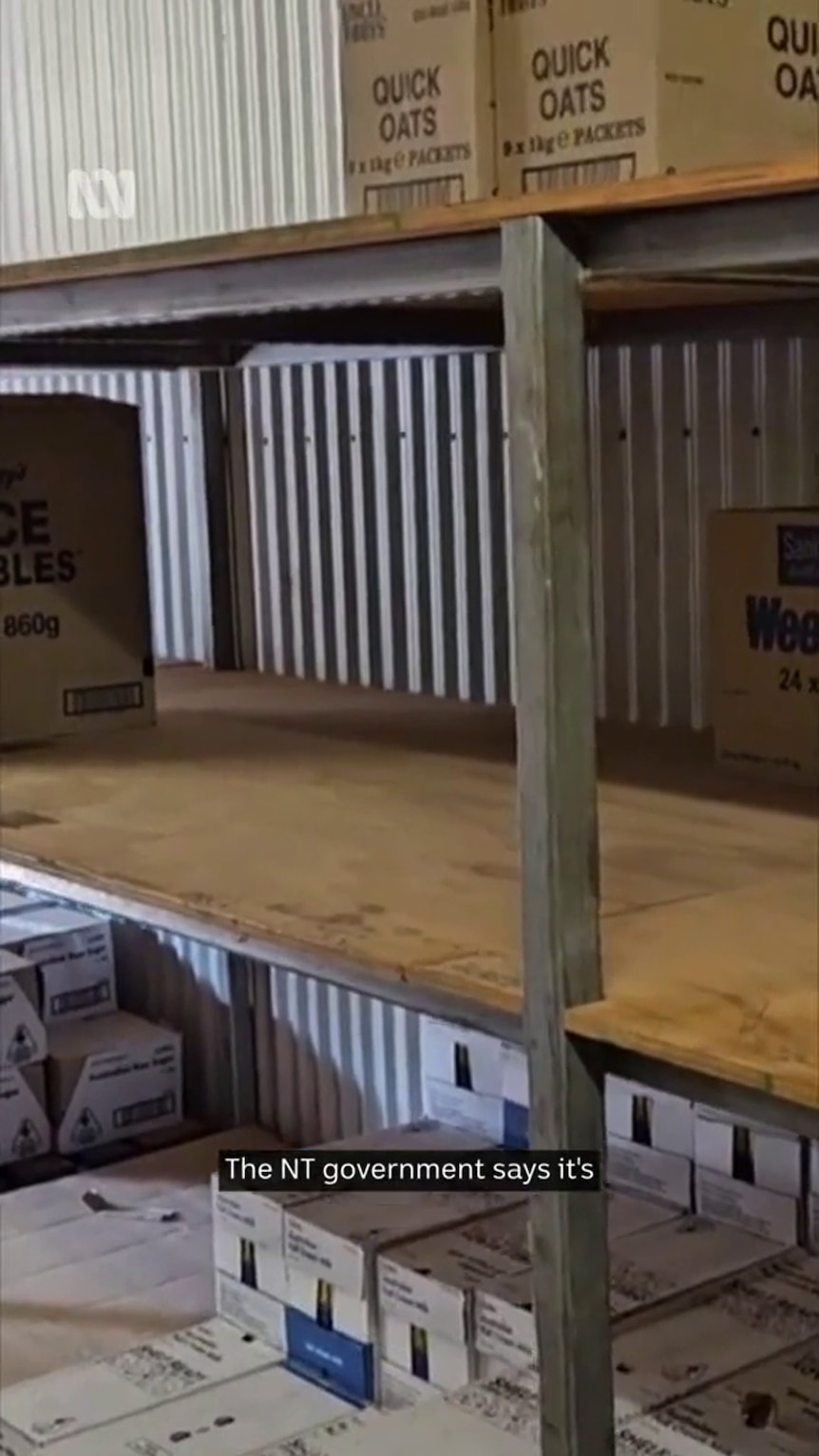 a simple wooden shop shelf is mostly bare with only some quick oats and other boxes visible