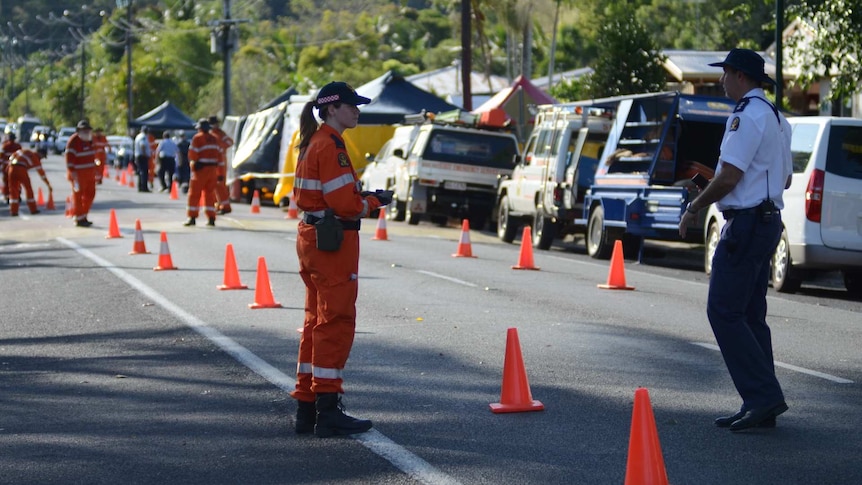 SES workers set up traffic controls at the scene of a brutal stabbing, in which eight children were killed.