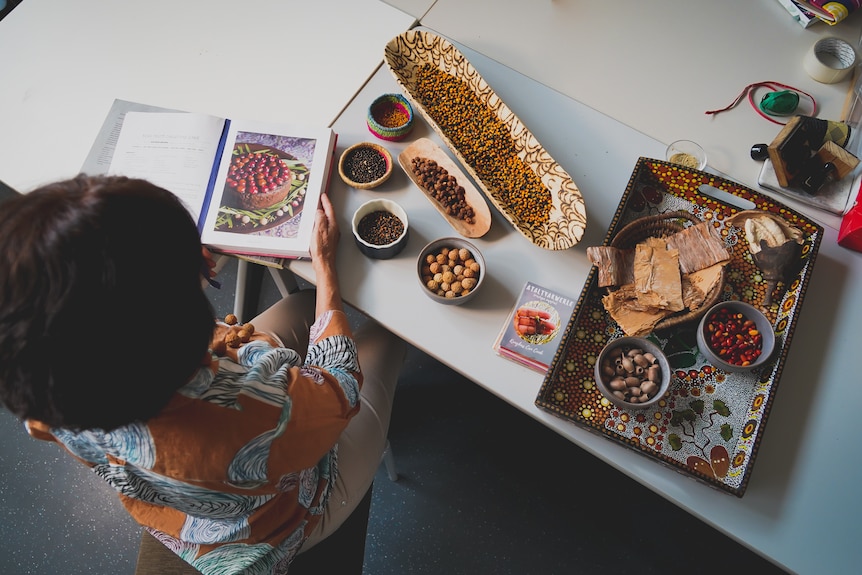 a woman with a cookbook looking into the distance