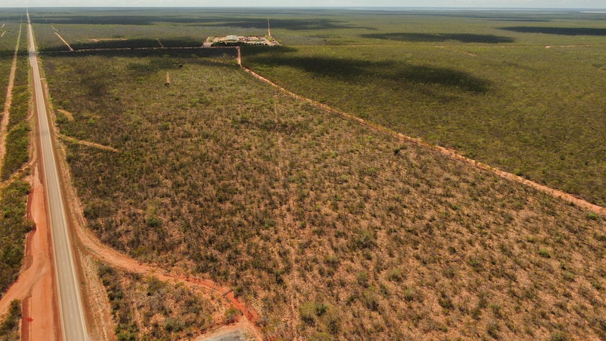 A drone shot of road and bush scrub.
