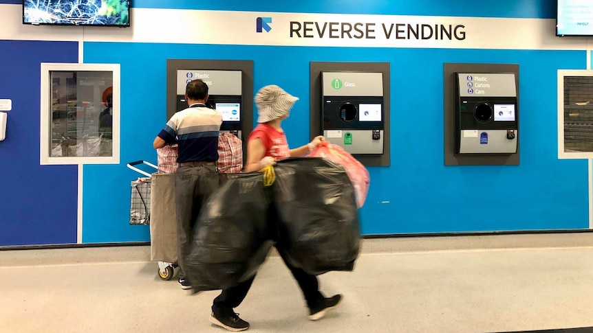 People depositing containers into a kiosk point in Brisbane.