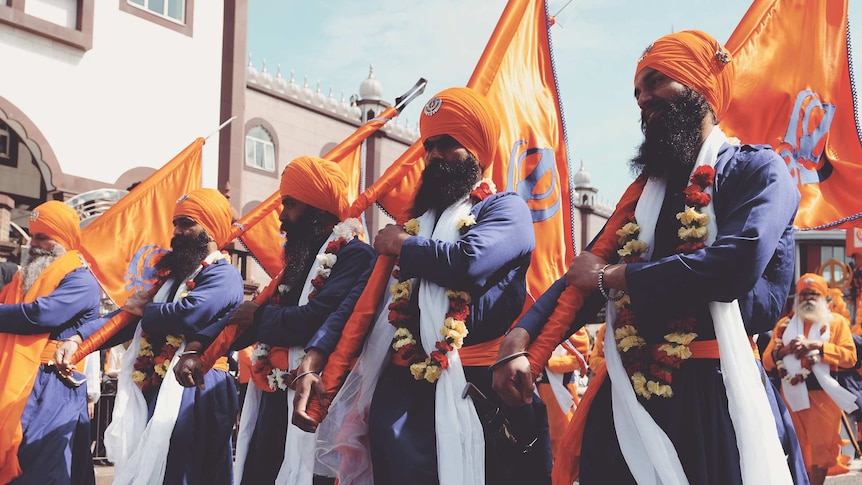 A Nagar Kirtan procession led by five saffron-robed Panj Piare