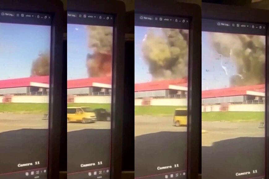 A blury picture of a screen showing smoke rising from a building