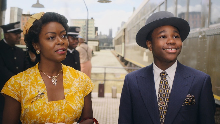 a woman in 1950s yello dress and young boy in blue suit and hat, playing emmett till and his mother in the film