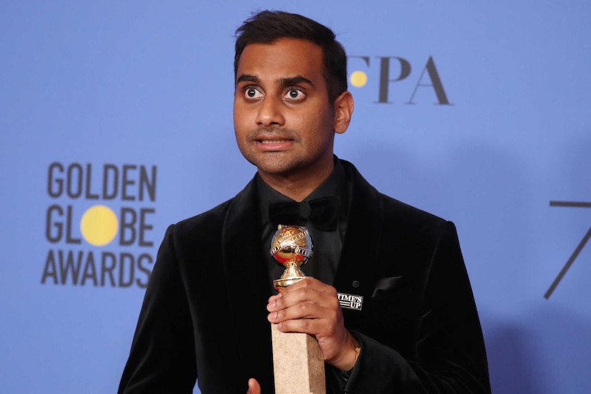 Aziz Ansari poses with the award for Best Performance by an Actor in a Television Series.