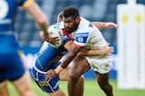 A rugby league player carries the ball 