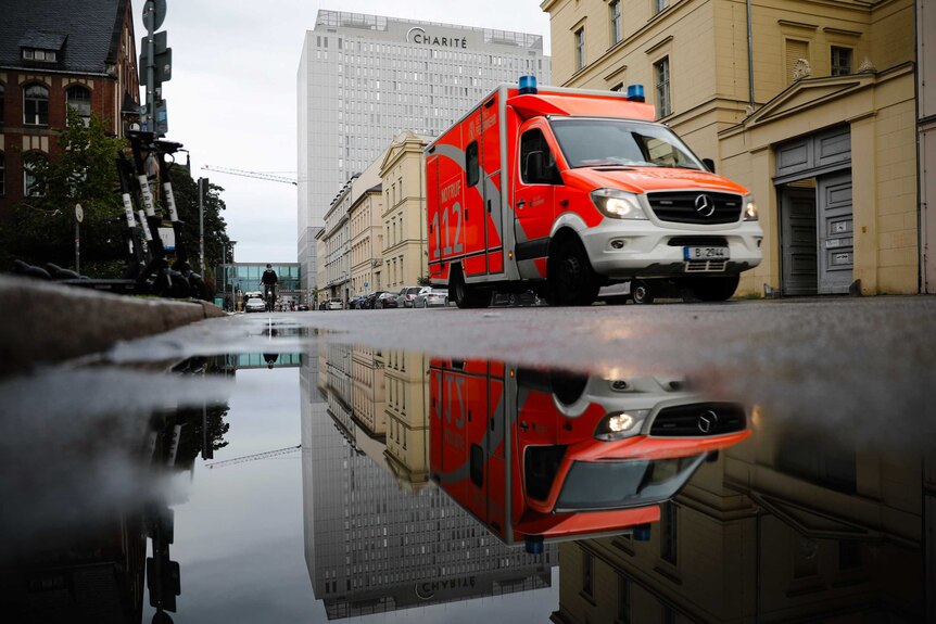 An orange ambulance sits on a Berlin street in front of the Charite hospital where Alexei Navalny is being treated.