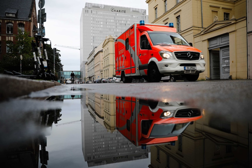 An orange ambulance sits on a Berlin street in front of the Charite hospital where Alexei Navalny is being treated.
