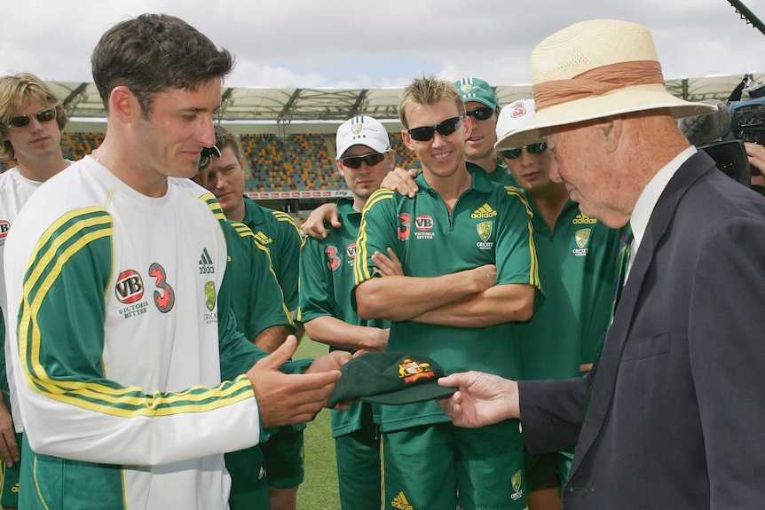 Proud moment ... Michael Hussey is presented with his Baggy Green Cap by Bill Brown before his first Test in 2005