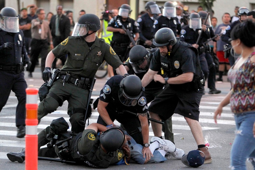 A protester is arrested by police officers in Anaheim.